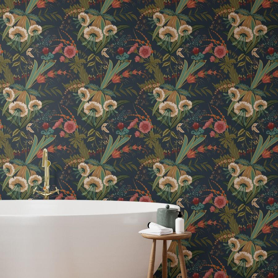 Freestanding white bathtub against a wall covered in dark botanical wallpaper with cream flowers, coral blooms, and lush green foliage.