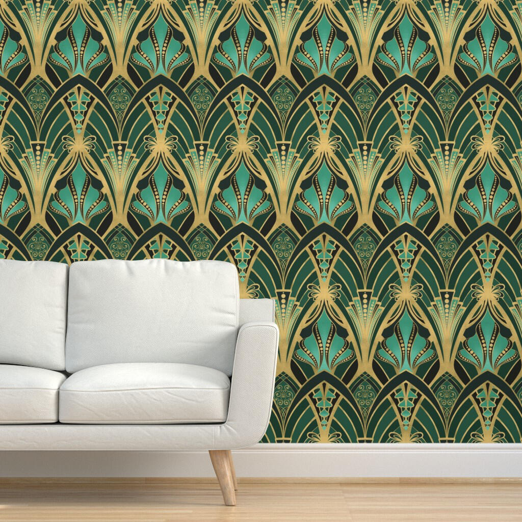 Untitled Art Deco wallpaper featuring gold geometric fan motifs on a deep teal and emerald background displayed behind a white sofa.